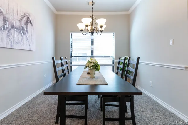 a view of a dining room with a table and chairs