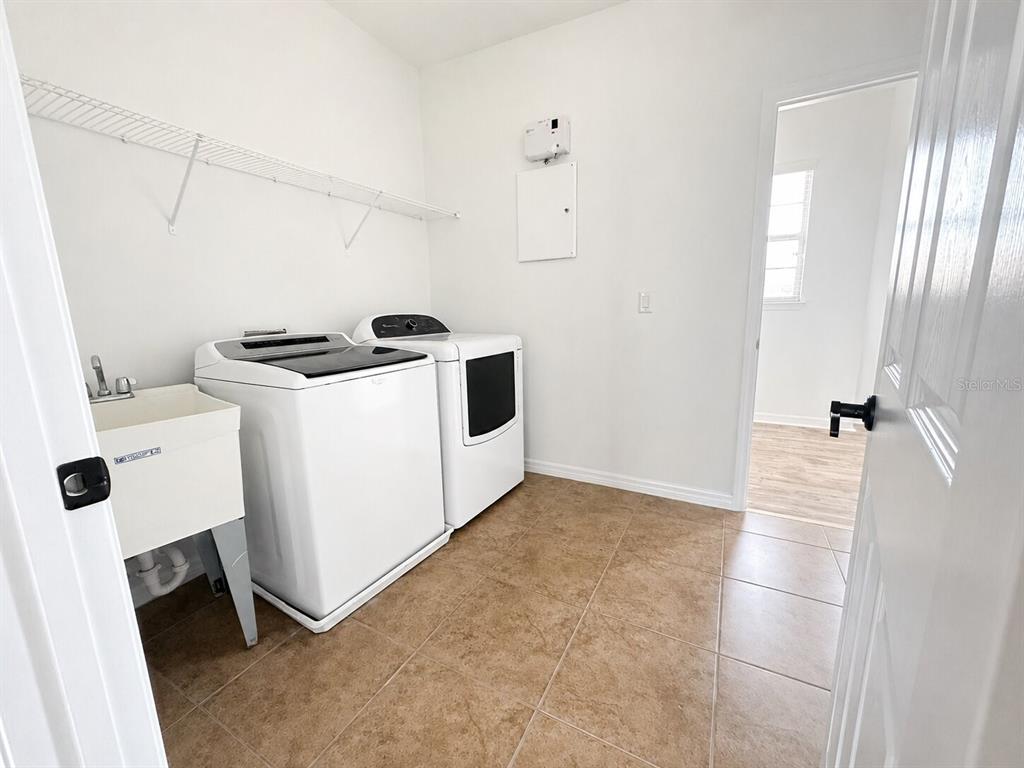 8531 Geddes Loop Orlando, FL 32836 - Photo 17 of 20 a view of utility room with washer and dryer