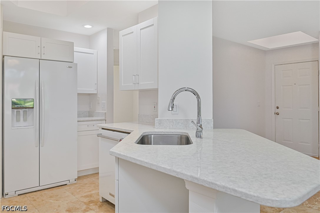 14967 Rivers Edge Court, Unit B1 Fort Myers, FL 33908 - Photo 13 of 36 a kitchen with a sink and refrigerator