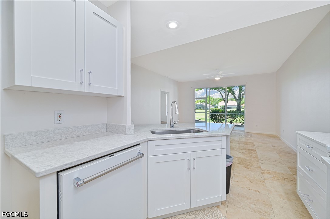 14967 Rivers Edge Court, Unit B1 Fort Myers, FL 33908 - Photo 16 of 36 a kitchen with a sink and cabinets