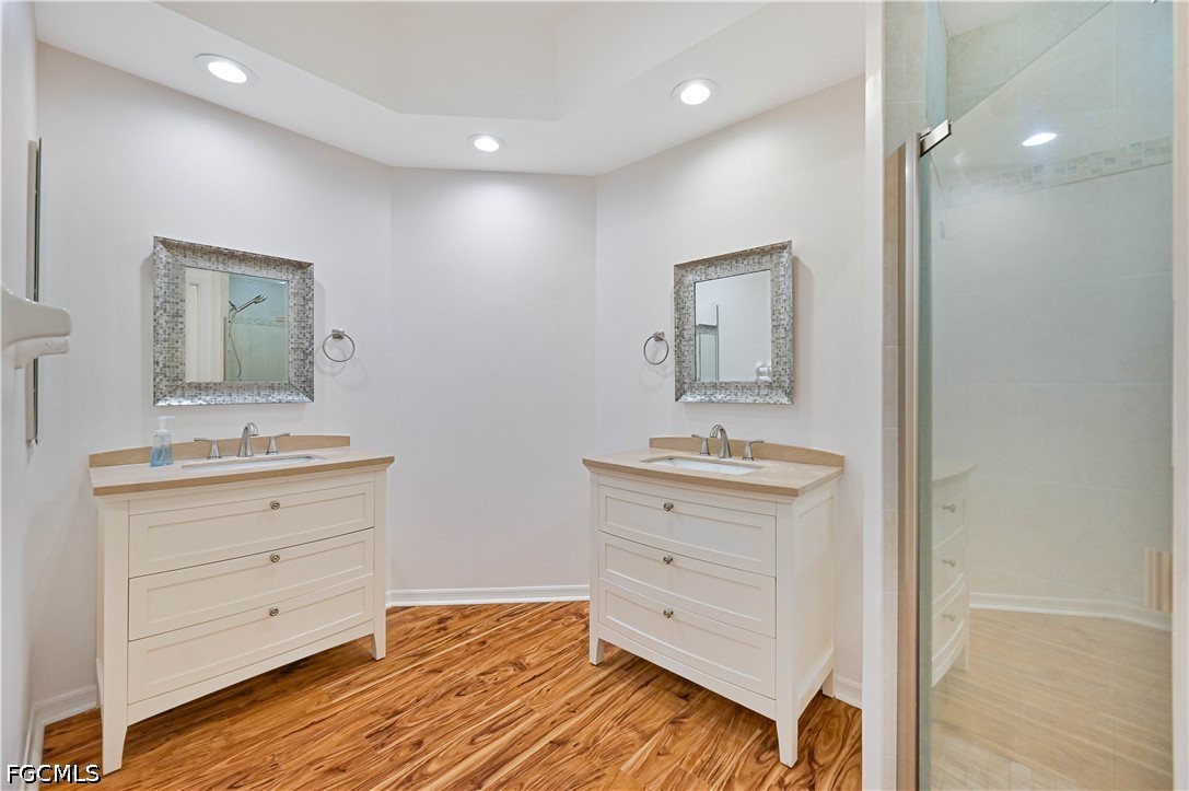 14967 Rivers Edge Court, Unit B1 Fort Myers, FL 33908 - Photo 24 of 36 a room with a dresser and a mirror