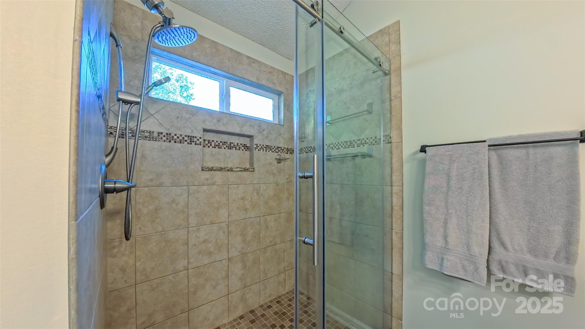 3693 Stonefield Street Southwest Concord, NC 28027 - Photo 11 of 27 a bathroom with a shower and a glass door