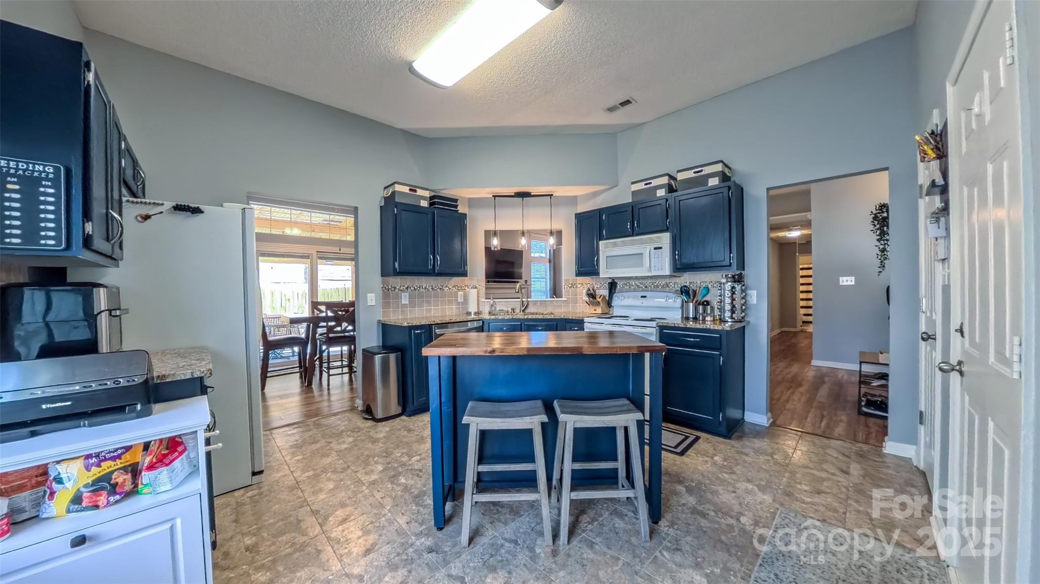 3693 Stonefield Street Southwest Concord, NC 28027 - Photo 14 of 27 a large kitchen with a table and chairs