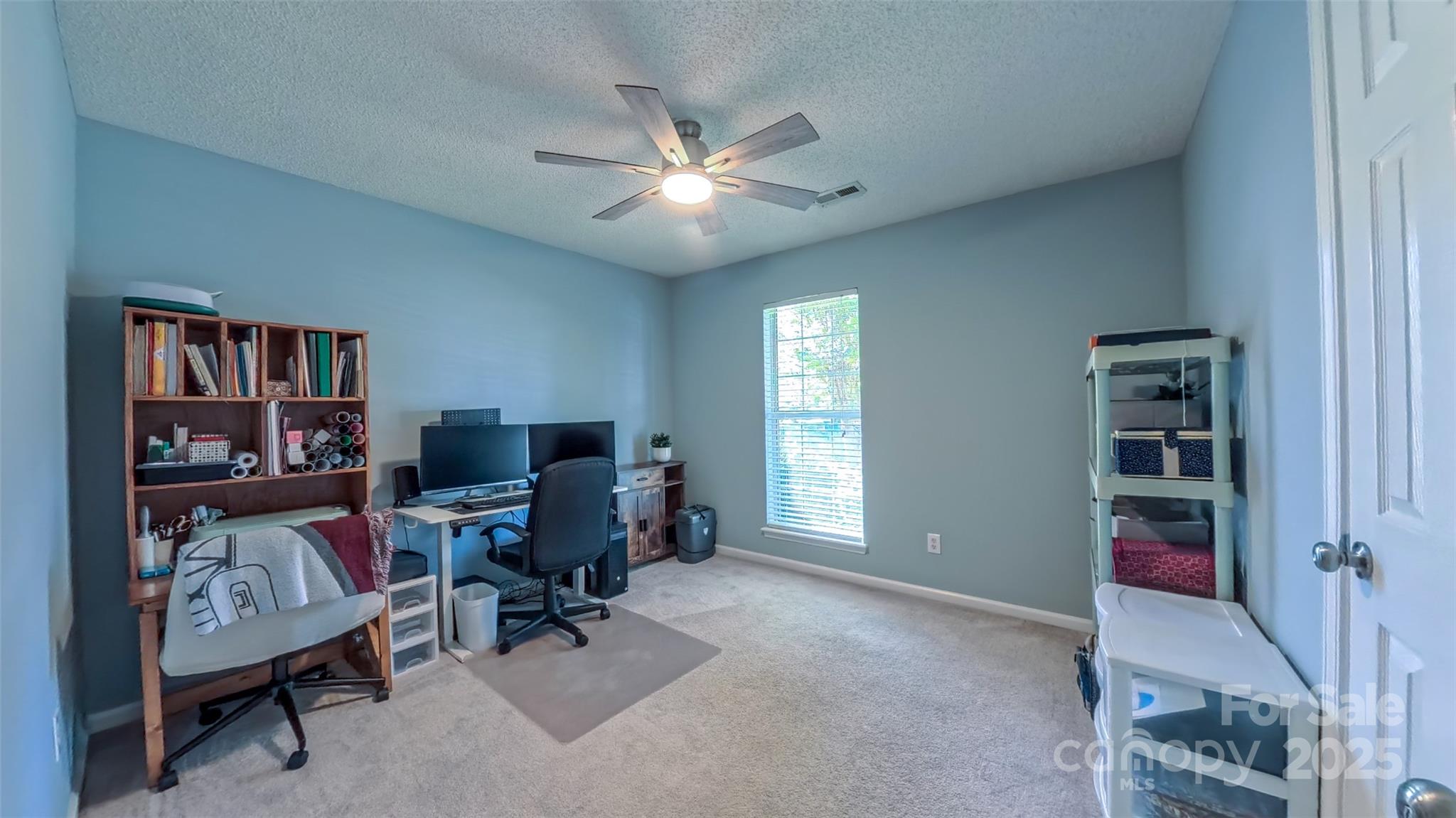 3693 Stonefield Street Southwest Concord, NC 28027 - Photo 20 of 27 a view of a workspace with furniture and a window