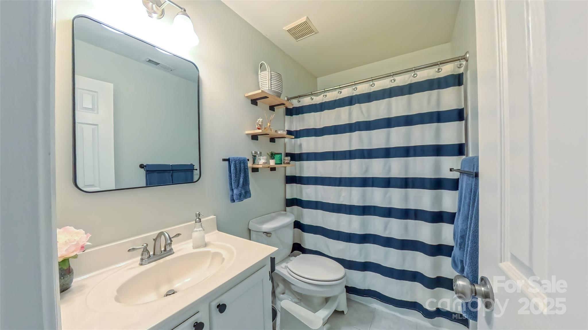 3693 Stonefield Street Southwest Concord, NC 28027 - Photo 21 of 27 a bathroom with a sink toilet and shower