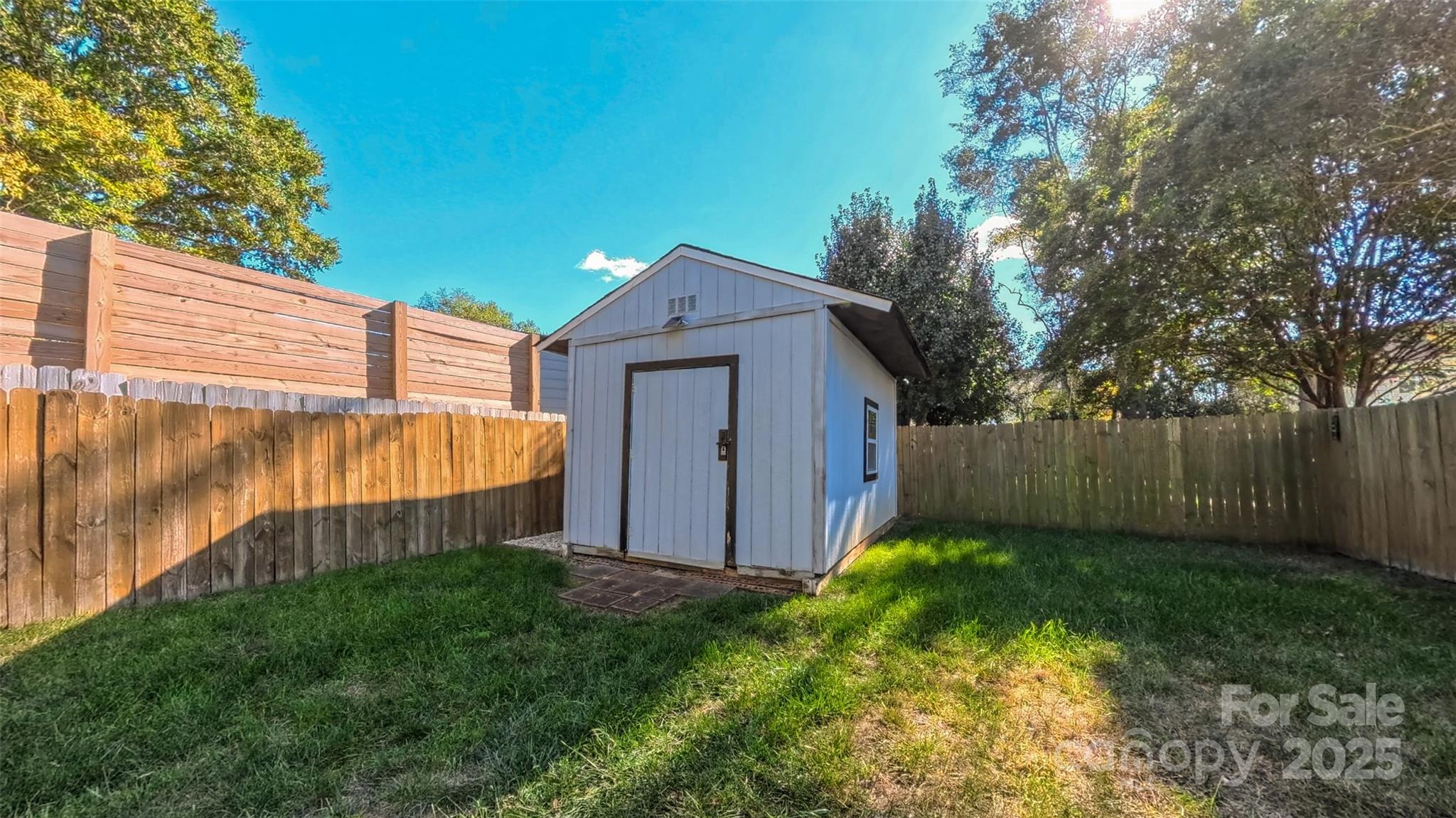 3693 Stonefield Street Southwest Concord, NC 28027 - Photo 24 of 27 a view of a backyard with barn and a large tree