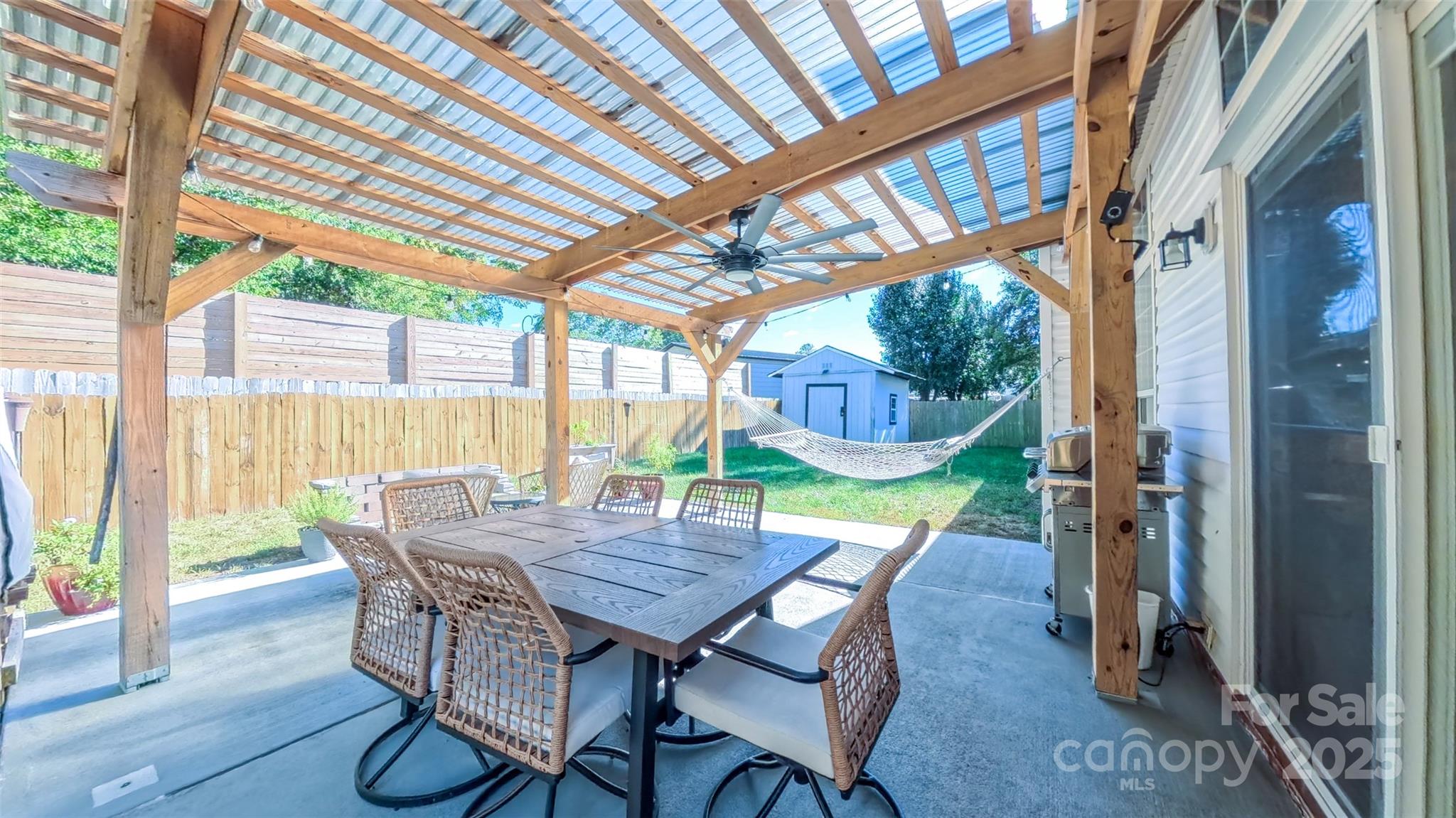 3693 Stonefield Street Southwest Concord, NC 28027 - Photo 26 of 27 a view of a patio with a table chairs and a backyard