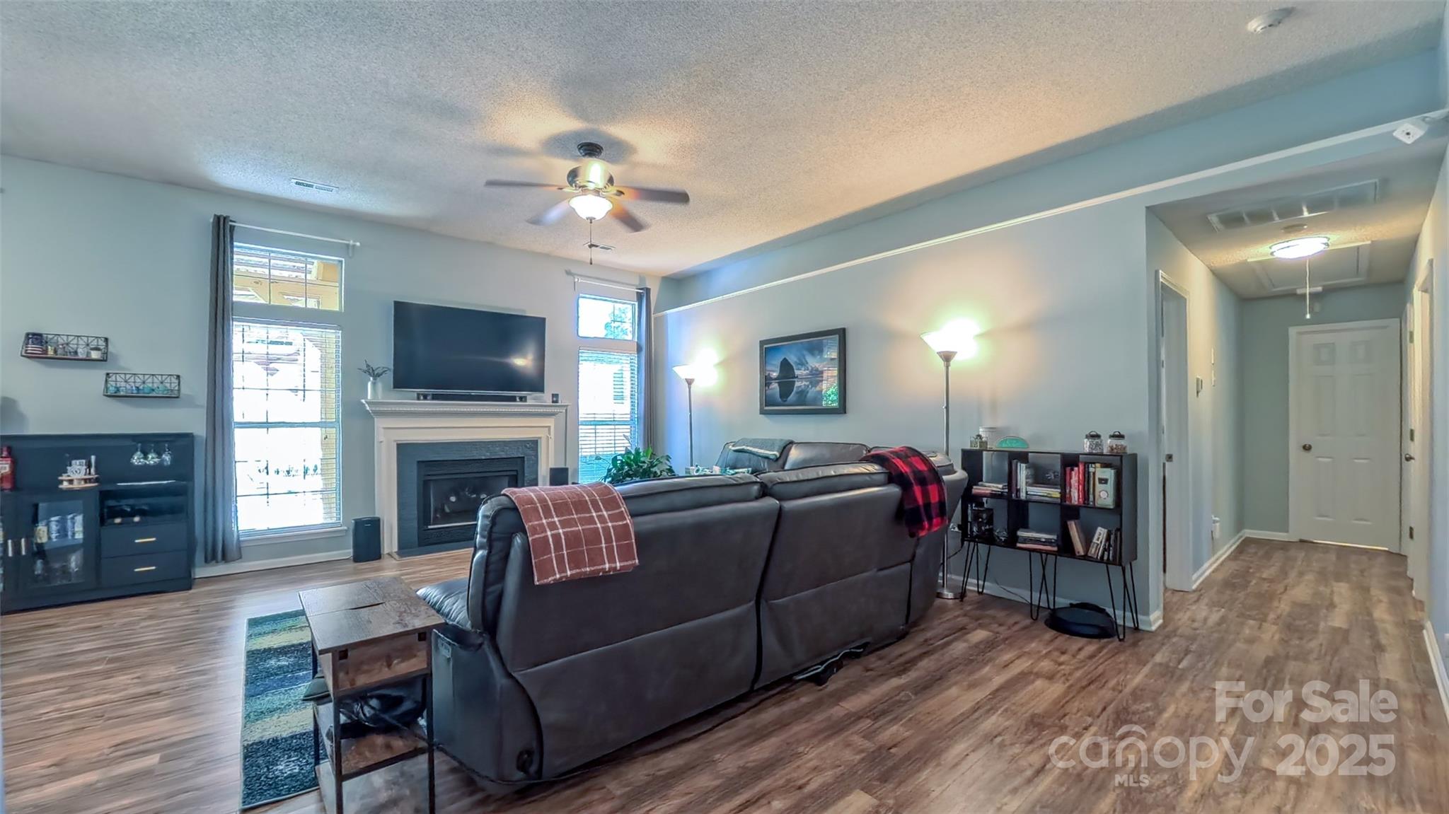 3693 Stonefield Street Southwest Concord, NC 28027 - Photo 3 of 27 a living room with furniture and a fireplace