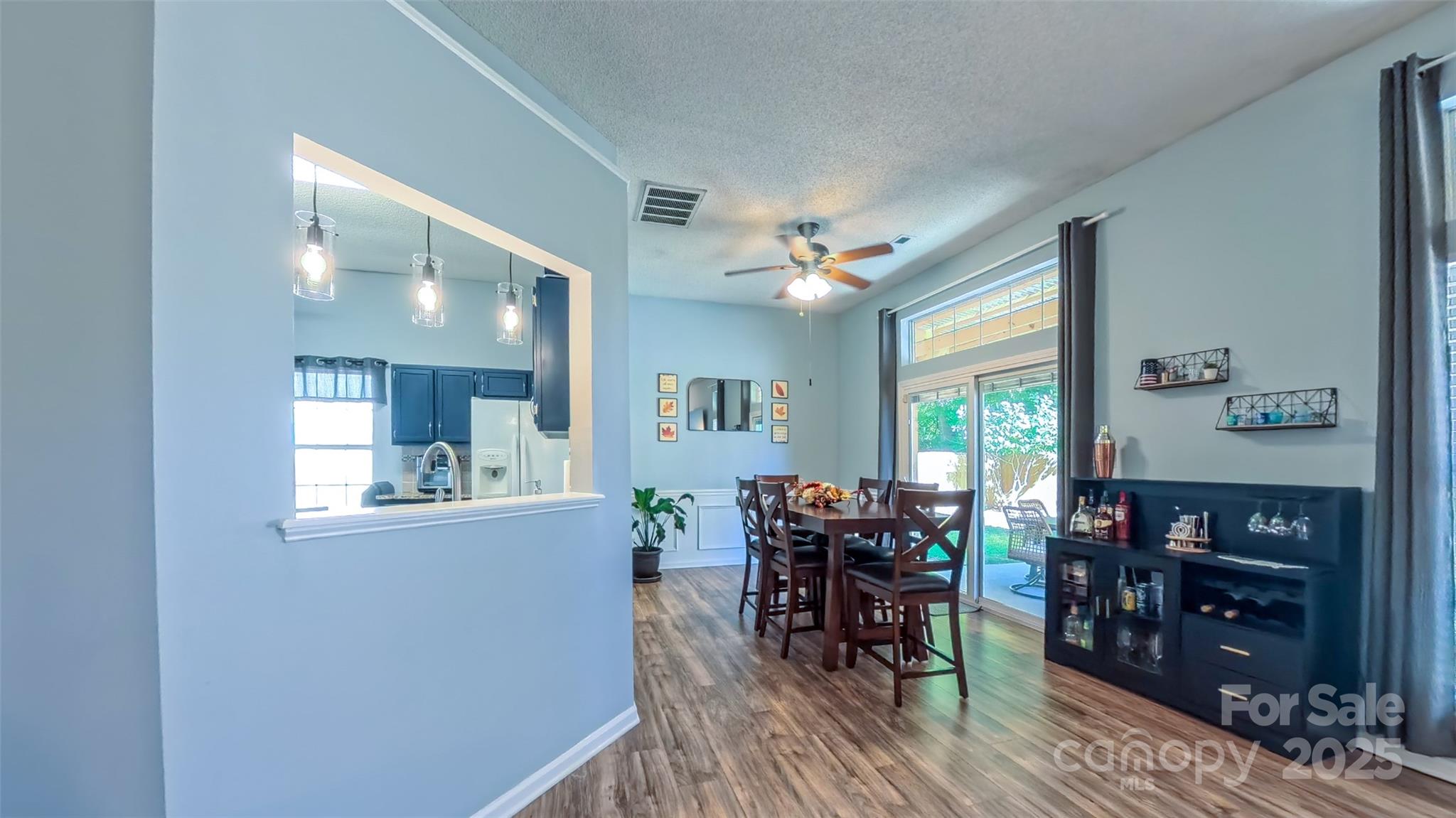 3693 Stonefield Street Southwest Concord, NC 28027 - Photo 4 of 27 a view of a dining room with furniture and chandelier