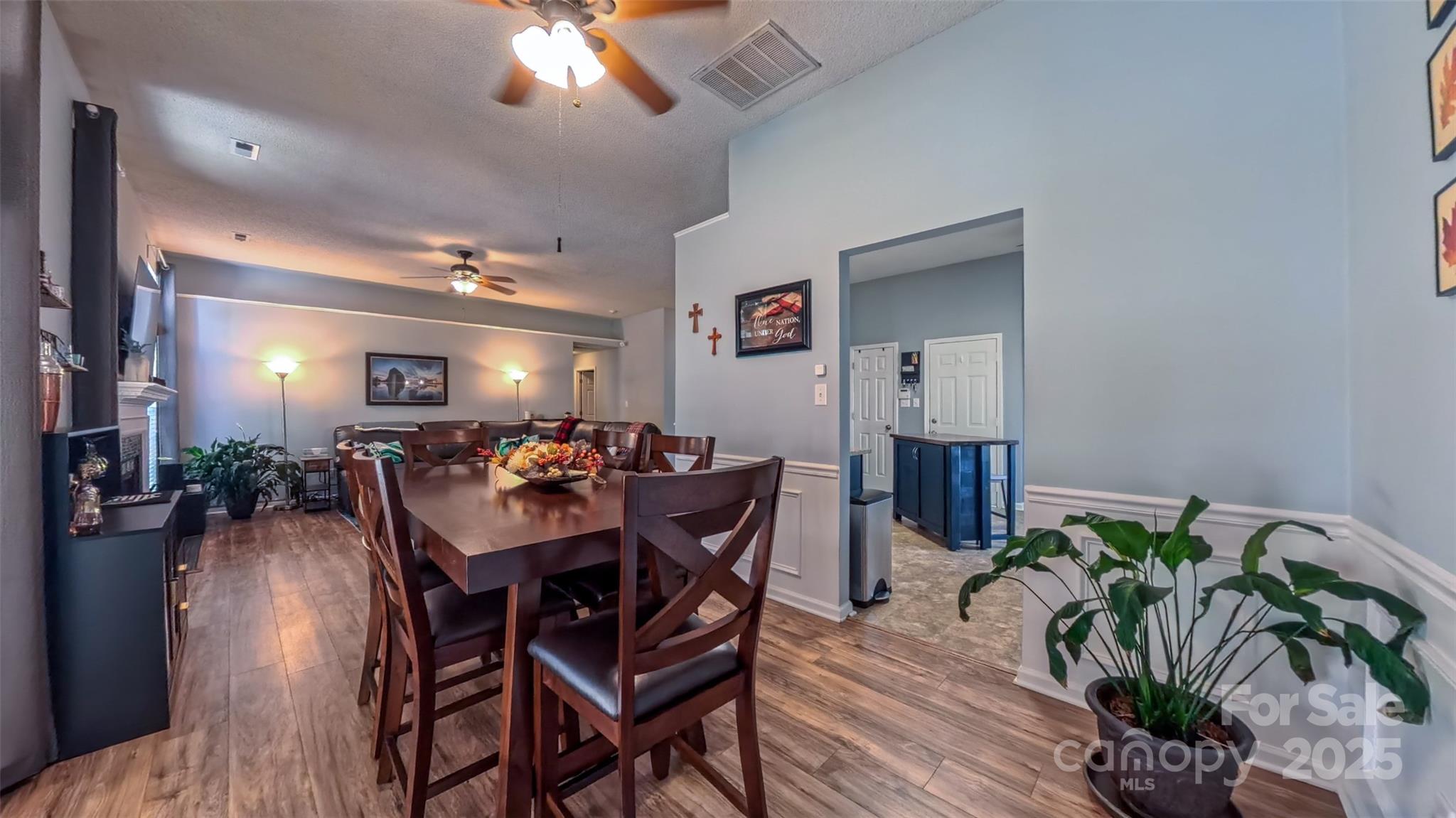 3693 Stonefield Street Southwest Concord, NC 28027 - Photo 5 of 27 a view of a dining room with furniture and chandelier