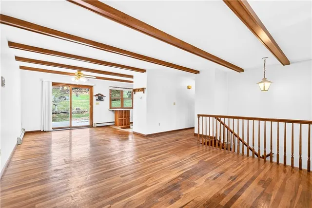 a view of an entryway with wooden floor