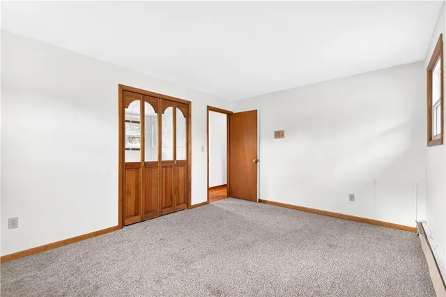 an empty room with windows and closet