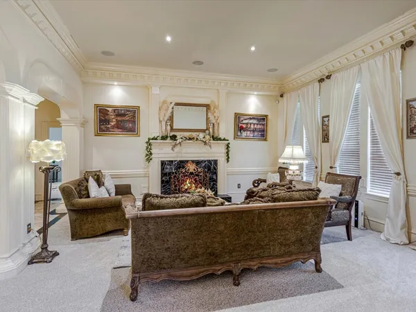 a view of a dining room with furniture and chandelier