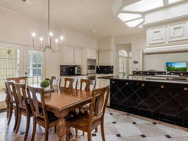 a kitchen with stainless steel appliances a stove a sink dishwasher a refrigerator and a oven