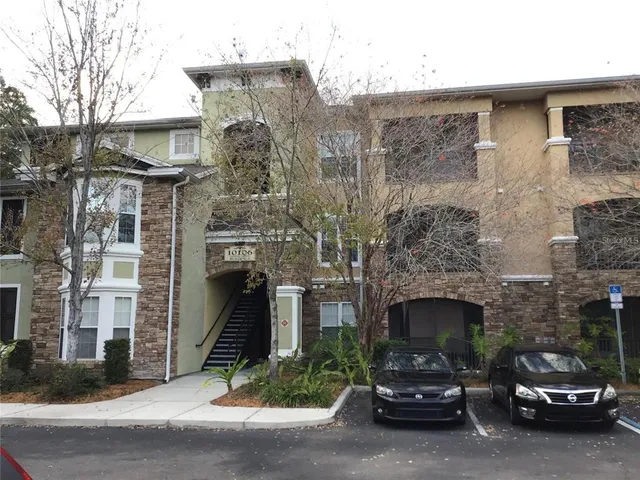 a car parked in front of a brick house