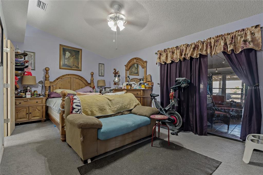 208 Limpkin Lane Frostproof, FL 33843 - Photo 26 of 60 a living room with furniture a ceiling fan and a window
