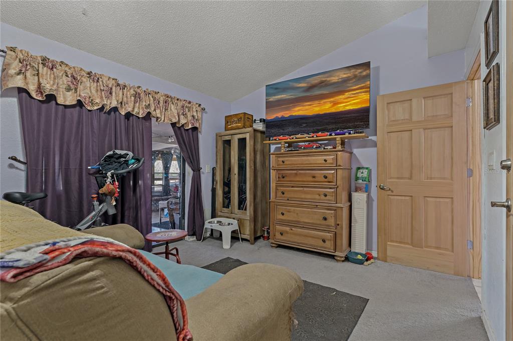 208 Limpkin Lane Frostproof, FL 33843 - Photo 28 of 60 a bedroom with a bed and a mirror