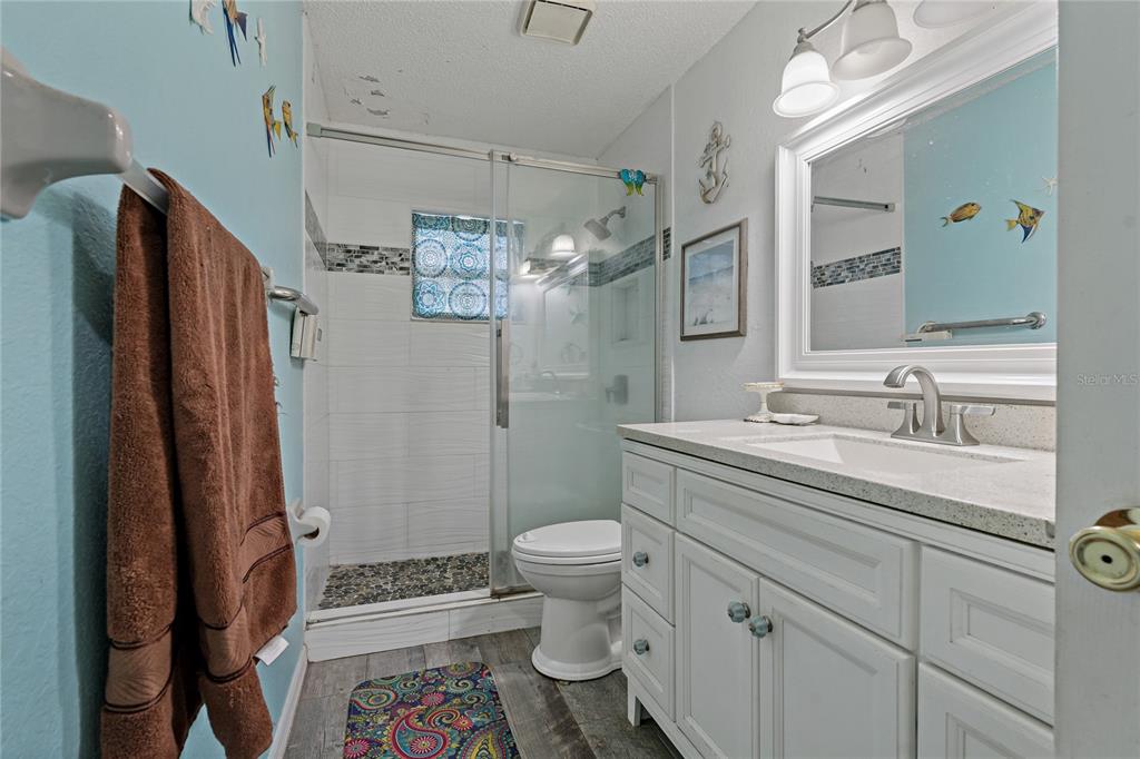 208 Limpkin Lane Frostproof, FL 33843 - Photo 34 of 60 a bathroom with a granite countertop sink toilet and shower