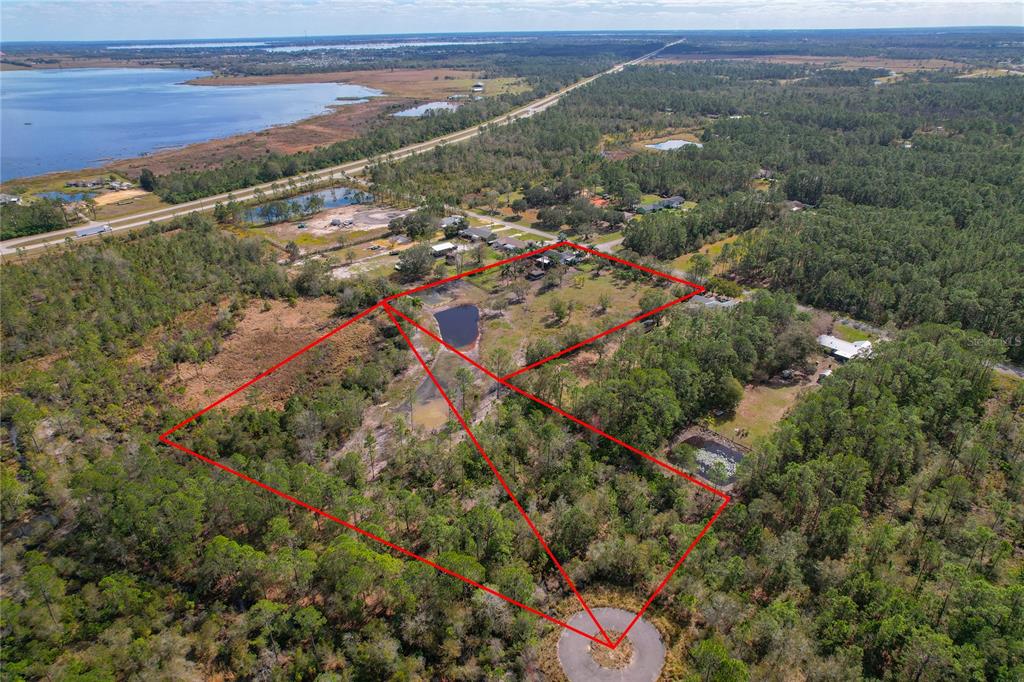 208 Limpkin Lane Frostproof, FL 33843 - Photo 5 of 60 an aerial view of residential houses with outdoor space and trees