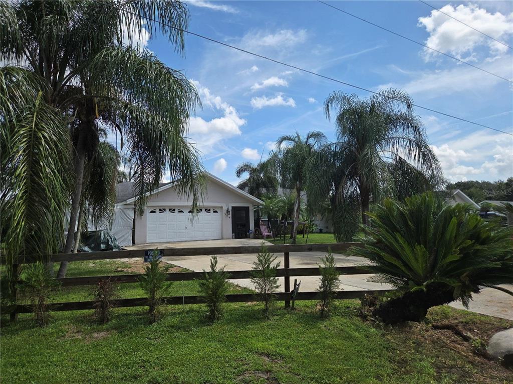 208 Limpkin Lane Frostproof, FL 33843 - Photo 57 of 60 a front view of a house with garden