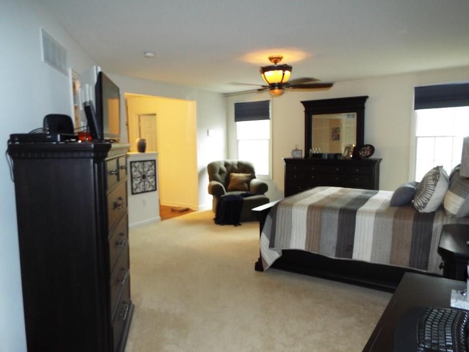 7007 Pin Oak Court McKees Rocks, PA 15136 - Photo 16 of 23 a bedroom with a bed and a chandelier