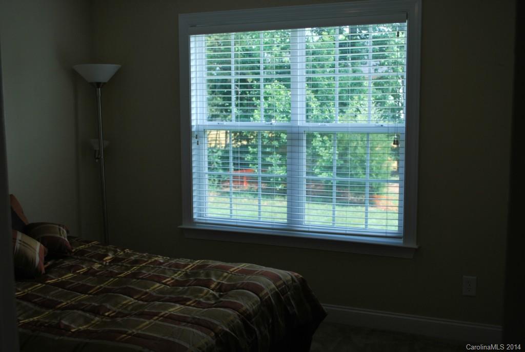 8612 Ridgeline Lane Charlotte, NC 28269 - Photo 17 of 20 a bed sitting in a bedroom next to a window
