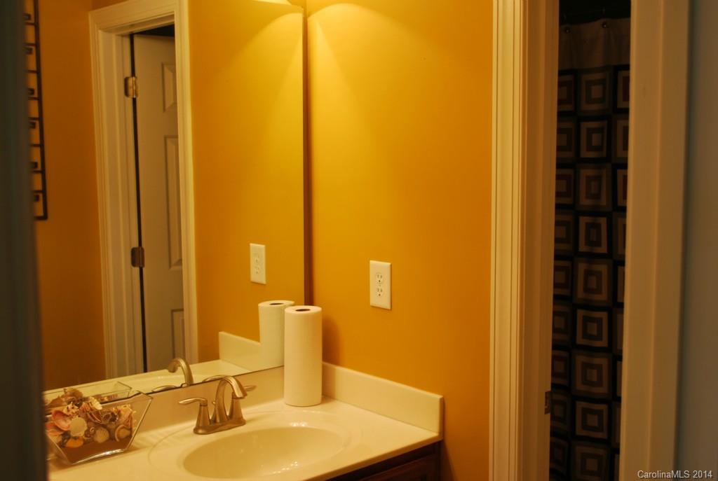 8612 Ridgeline Lane Charlotte, NC 28269 - Photo 18 of 20 a bathroom with a sink and a mirror