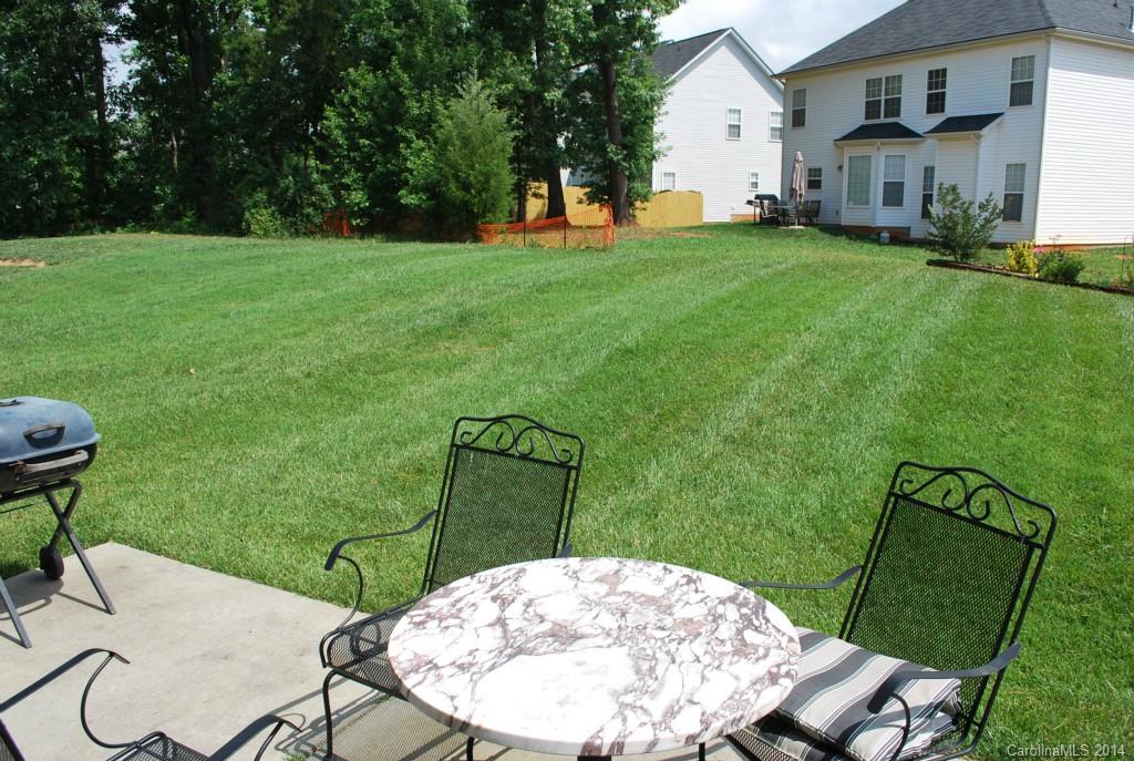 8612 Ridgeline Lane Charlotte, NC 28269 - Photo 20 of 20 a backyard of a house with table and chairs