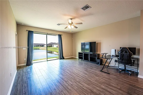 a view of livingroom with furniture wooden floor and windows