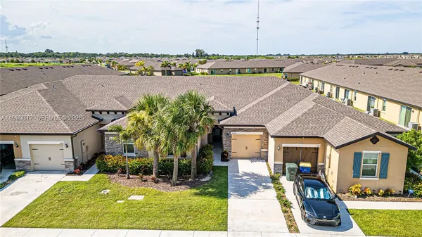 an aerial view of a house with garden space and lake view