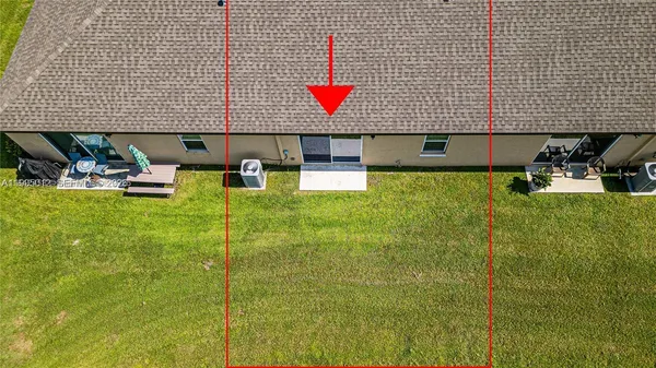 a aerial view of a house with swimming pool and a yard