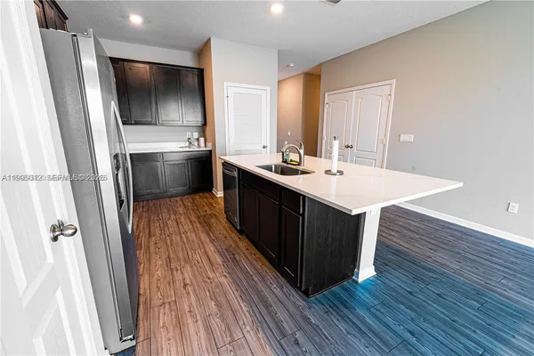 a kitchen with a sink appliances and cabinets