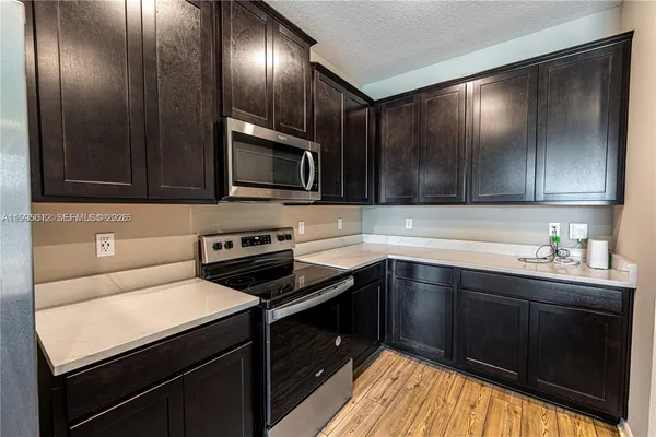 a kitchen with sink cabinets and stainless steel appliances
