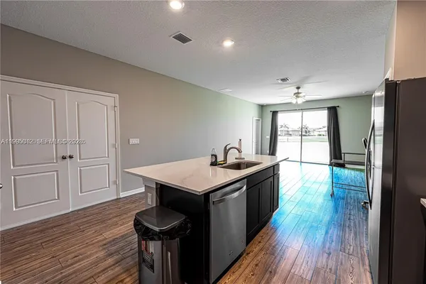 a kitchen with a sink and wooden floor