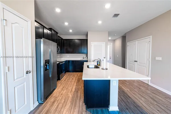 a kitchen with stainless steel appliances a refrigerator and a sink