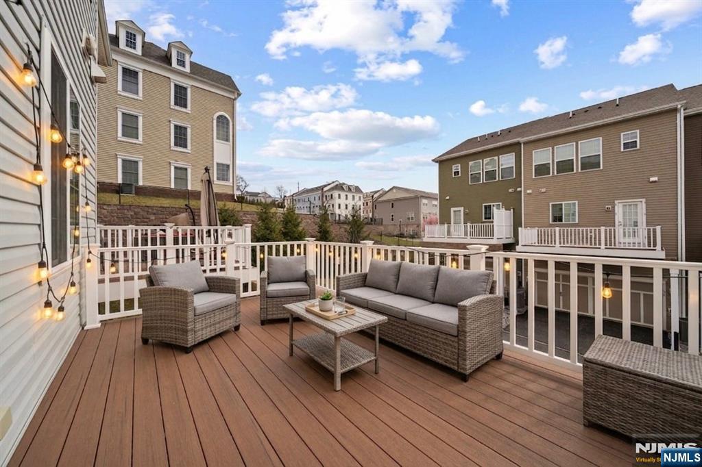 129 Truman Drive Wood-Ridge, NJ 07075 - Photo 20 of 47 a view of a balcony with couch and wooden floor