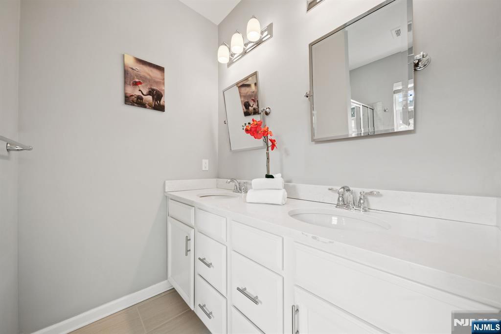 129 Truman Drive Wood-Ridge, NJ 07075 - Photo 28 of 47 a bathroom with a double vanity sink and a mirror