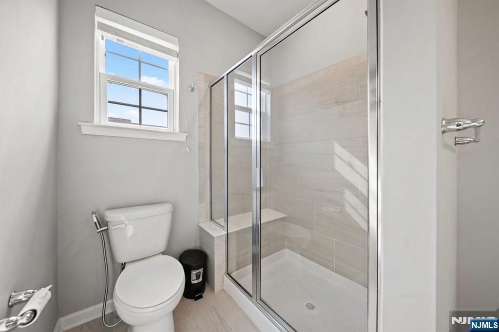 129 Truman Drive Wood-Ridge, NJ 07075 - Photo 29 of 47 a white toilet sitting next to a bathroom sink