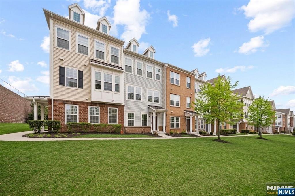 129 Truman Drive Wood-Ridge, NJ 07075 - Photo 3 of 47 a front view of a building with a garden