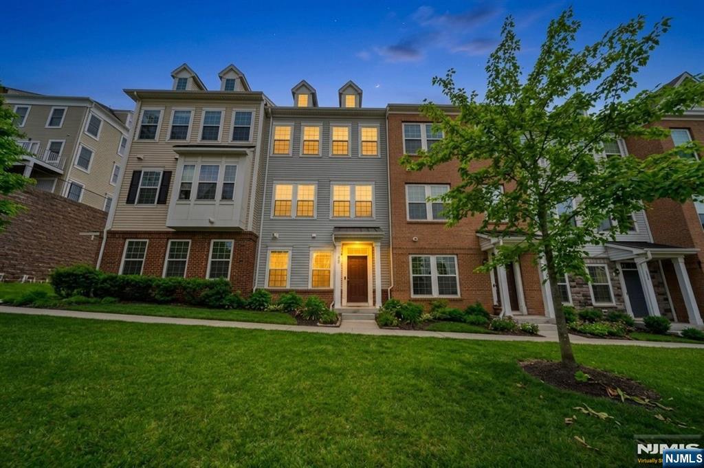 129 Truman Drive Wood-Ridge, NJ 07075 - Photo 4 of 47 a front view of a residential apartment building with a yard