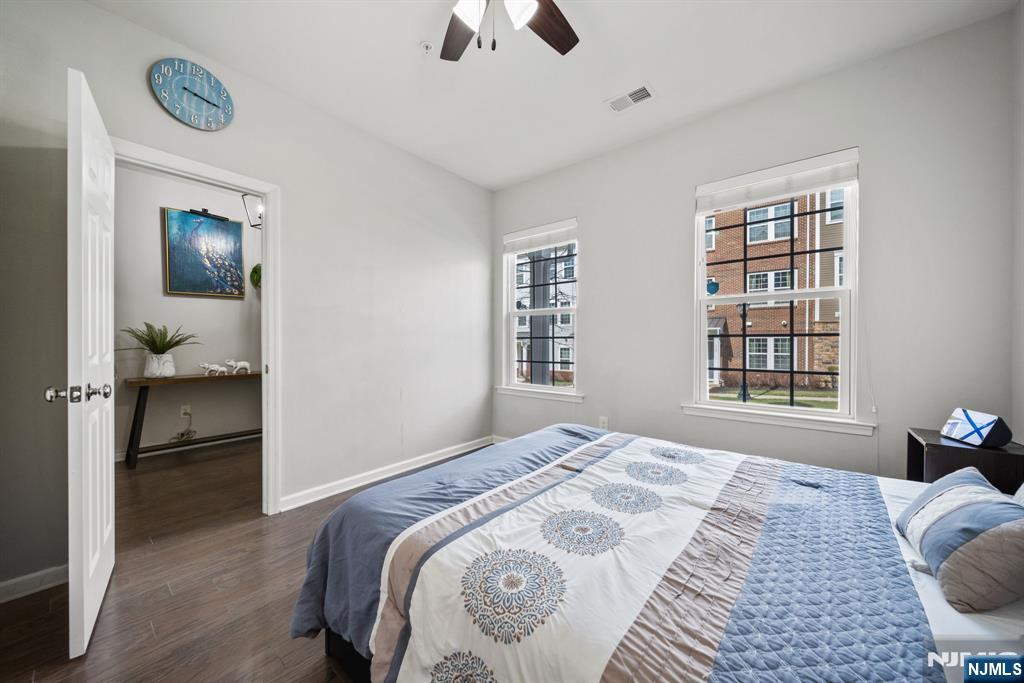 129 Truman Drive Wood-Ridge, NJ 07075 - Photo 7 of 47 a bedroom with a bed and a chandelier