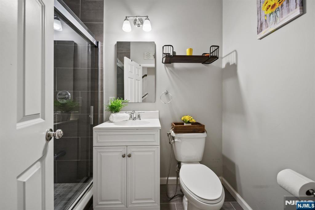129 Truman Drive Wood-Ridge, NJ 07075 - Photo 8 of 47 a bathroom with a sink a toilet and shower