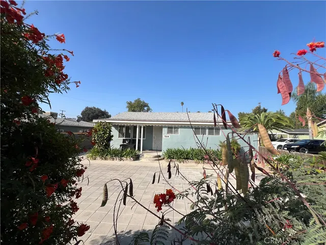 a view of a house with outdoor seating