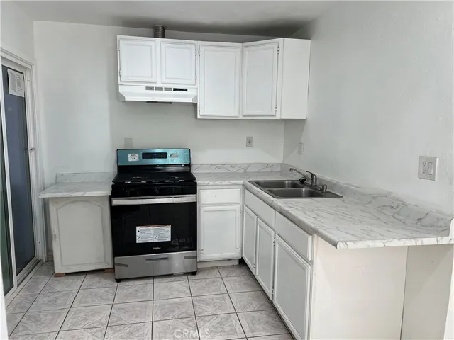 a kitchen with cabinets appliances and a sink