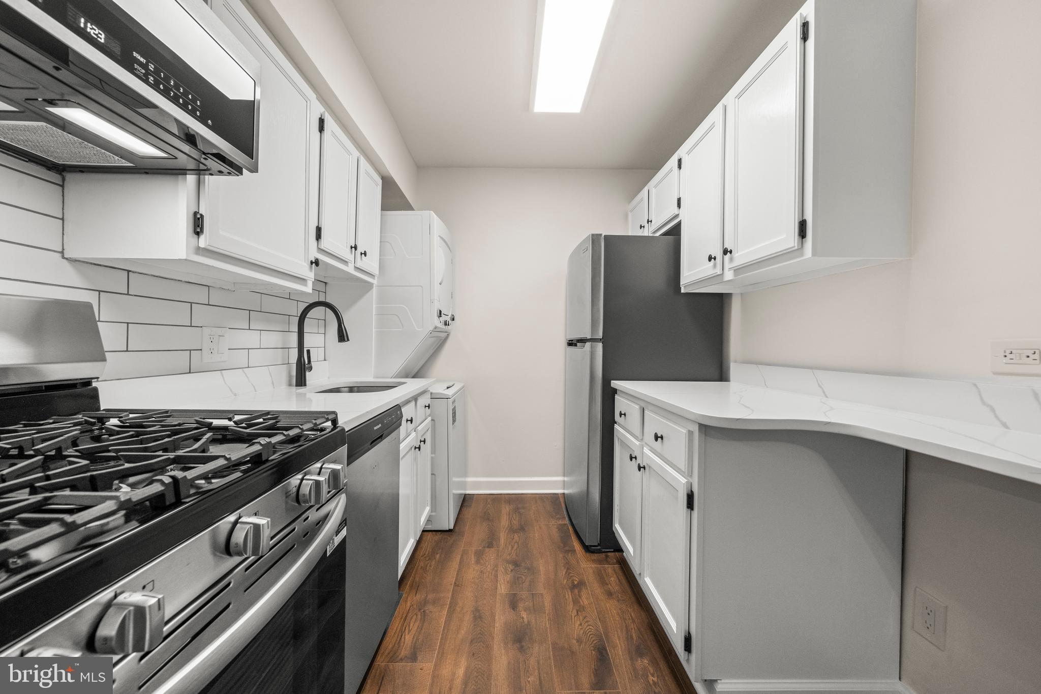 1134 South Washington Street, Unit T1 Falls Church, VA 22046 - Photo 11 of 34 a kitchen with stainless steel appliances a sink stove and cabinets