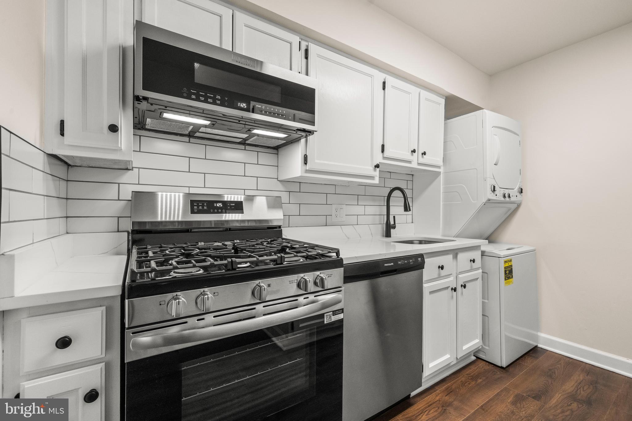 1134 South Washington Street, Unit T1 Falls Church, VA 22046 - Photo 12 of 34 a kitchen with stainless steel appliances a sink a stove and cabinets