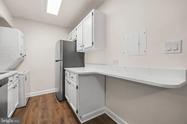 a kitchen with cabinets and a stainless steel appliances