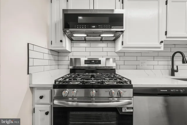 a kitchen with a stove and cabinets