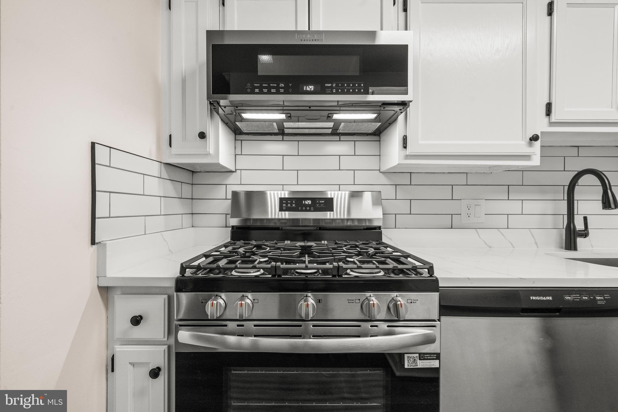 1134 South Washington Street, Unit T1 Falls Church, VA 22046 - Photo 14 of 34 a kitchen with a stove and cabinets