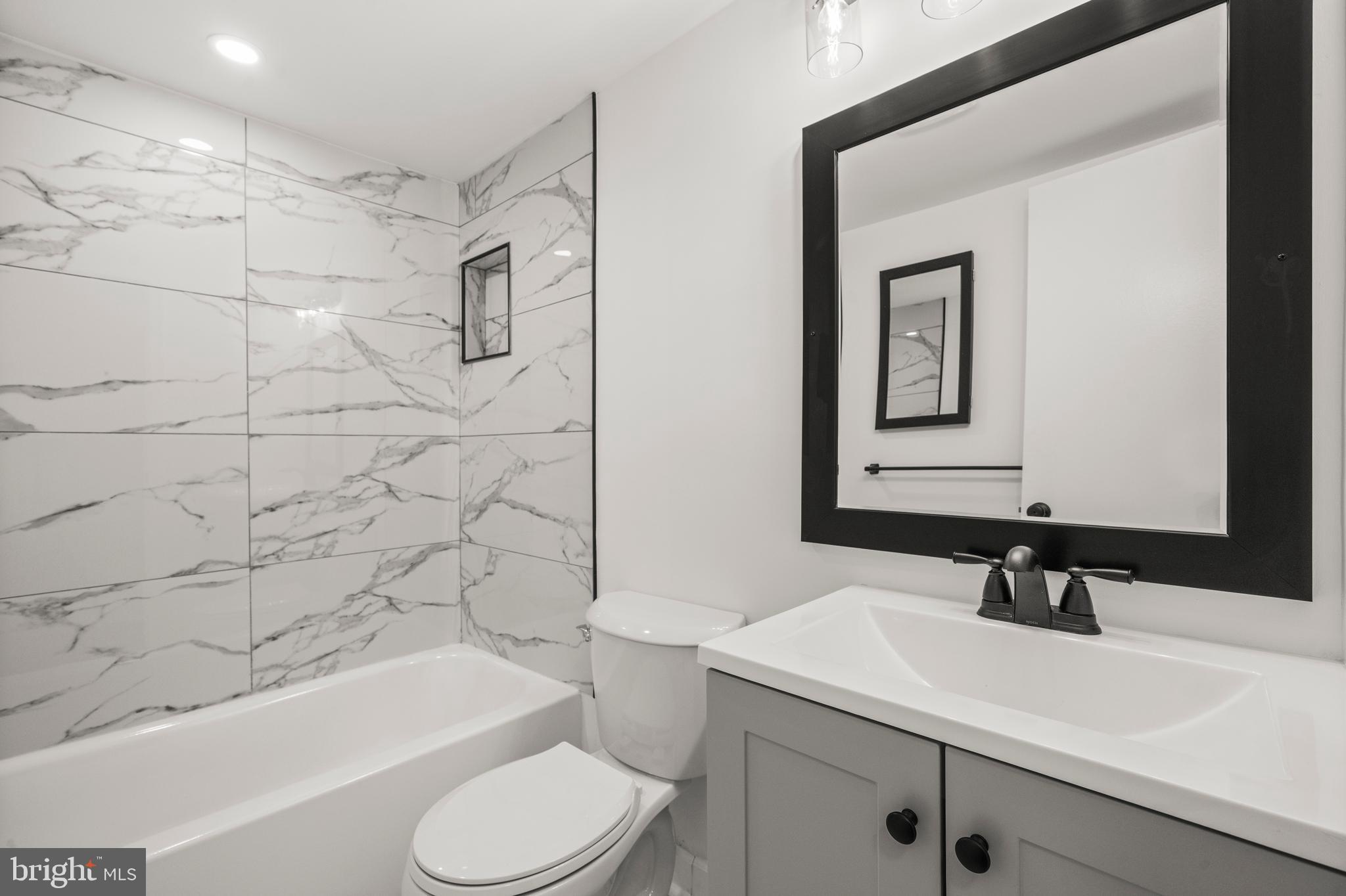 1134 South Washington Street, Unit T1 Falls Church, VA 22046 - Photo 18 of 34 a bathroom with a sink a toilet and shower